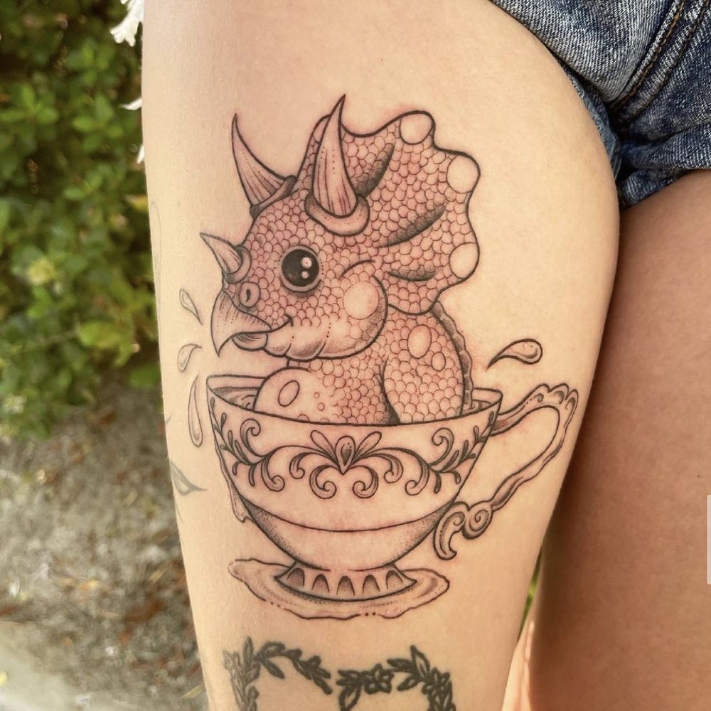 Devoted Ink - Image description: Triceratops in a tea cup on right thigh Tatted by Barbie - Tattoo Near Me - Temecula, California