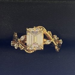 Emerald cut diamond floral engagement ring
