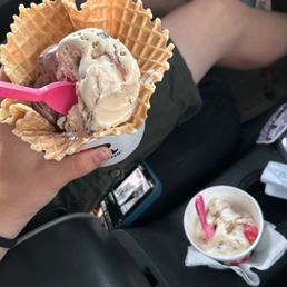 a person eating ice cream in a waffle cone a person eating ice cream in a waffle cone