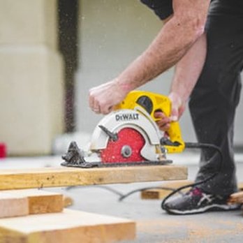 JV Construction - a man using a circular saw - Handyman Near Me JV Construction - a man using a circular saw - Handyman Near Me