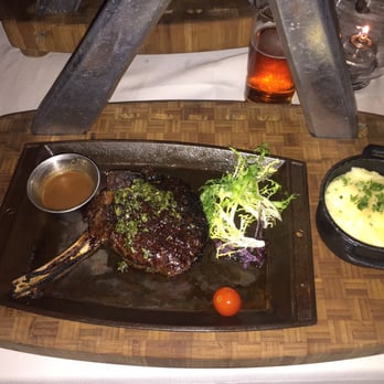 Barton G - Cowgirl rib eye wth mashed potatoes - New American Near Me - Miami Beach, Florida