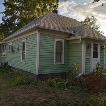 Patriot Home Services - a green house with a brown roof - Roofing Near Me Patriot Home Services - a green house with a brown roof - Roofing Near Me