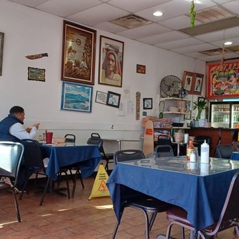 La Libertad - a man sitting at a table in a restaurant - Salvadoran Near Me - Pelham, Alabama