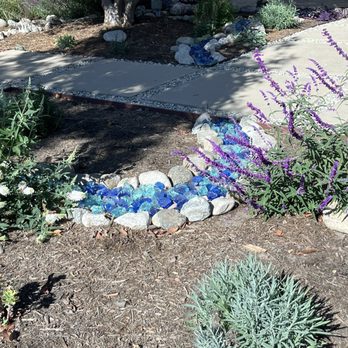 Growscapes - Native plants and dry creak with blue landscaping glass - Landscaping Near Me Growscapes - Native plants and dry creak with blue landscaping glass - Landscaping Near Me