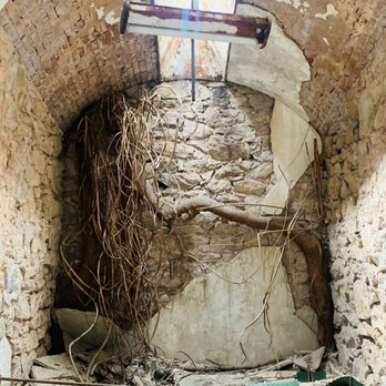 Eastern State Penitentiary - Inside one of the cell, outgrow tree and old bed frame a small skyline. - Landmarks & Historical Buildings Near Me - Philadelphia, Pennsylvania Eastern State Penitentiary - Inside one of the cell, outgrow tree and old bed frame a small skyline. - Landmarks & Historical Buildings Near Me - Philadelphia, Pennsylvania