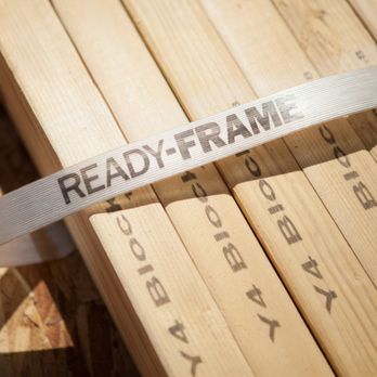 Builders FirstSource - Close-up image of a strapped bundle of pre-cut, labeled lumber with a white band reading "READY-FRAME®" from Builders FirstSo... - Building Supplies Near Me - West Jordan, Utah Builders FirstSource - Close-up image of a strapped bundle of pre-cut, labeled lumber with a white band reading "READY-FRAME®" from Builders FirstSo... - Building Supplies Near Me - West Jordan, Utah