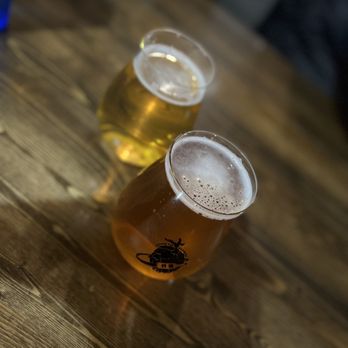 Angry Chicken - two glasses of beer on a wooden table - Chicken Wings Near Me - Aurora, Colorado