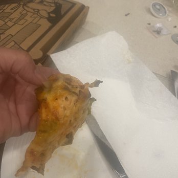 Jenk's Pizza - a hand holding a piece of pizza - Pizza Near Me - St Johns, Florida