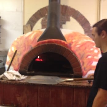 The Pizza Joint - August manning the wood fired oven. - Pizza Near Me - Crystal River, Florida The Pizza Joint - August manning the wood fired oven. - Pizza Near Me - Crystal River, Florida
