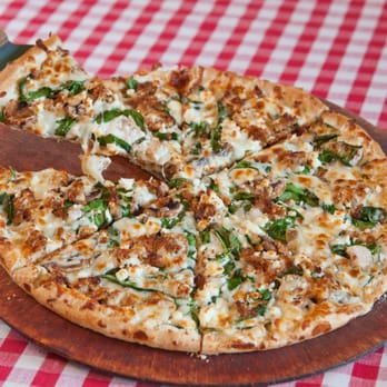 Romeos Pizza - a sliced pizza on a wooden board - Pizza Near Me - Topsham, Maine