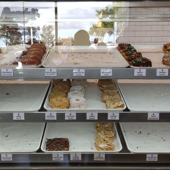 Randy’s Donuts - Not much selection left in this display - Coffee & Tea Near Me - San Diego, California