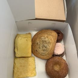 Assorted baked goods Lemon Bar Cinnamon Sugar Donut Chocolate Chip Cookie Strawberry Donut Olive Oil Mini Loaf Assorted baked goods Lemon Bar Cinnamon Sugar Donut Chocolate Chip Cookie Strawberry Donut Olive Oil Mini Loaf