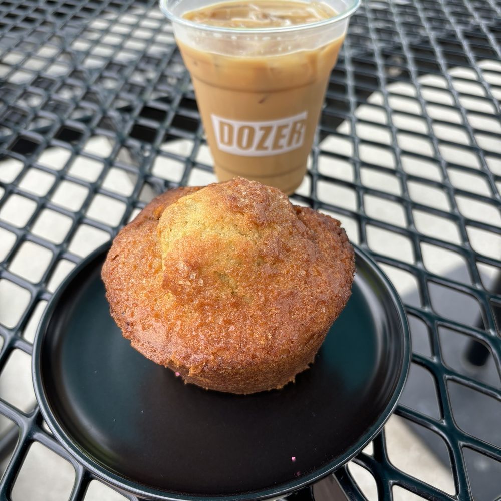 Blueberry muffin and an iced horchata latte on their outdoor patio table Blueberry muffin and an iced horchata latte on their outdoor patio table