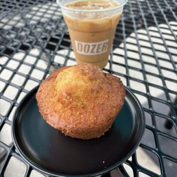 Blueberry muffin and an iced horchata latte on their outdoor patio table