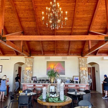 Calcareous Vineyard - a dining room with a chandelier - Wine Tasting Room Near Me - Paso Robles, California