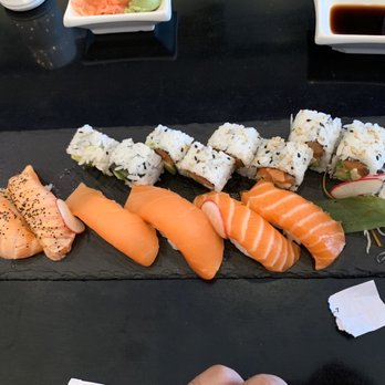 Top Sushi - Philadelphia Roll on top row, Pepper Salmon, Smoked Salmon, and Salmon Nigiri on bottom row from left to right. - Sushi Bars Near Me - Cypress, Texas Top Sushi - Philadelphia Roll on top row, Pepper Salmon, Smoked Salmon, and Salmon Nigiri on bottom row from left to right. - Sushi Bars Near Me - Cypress, Texas