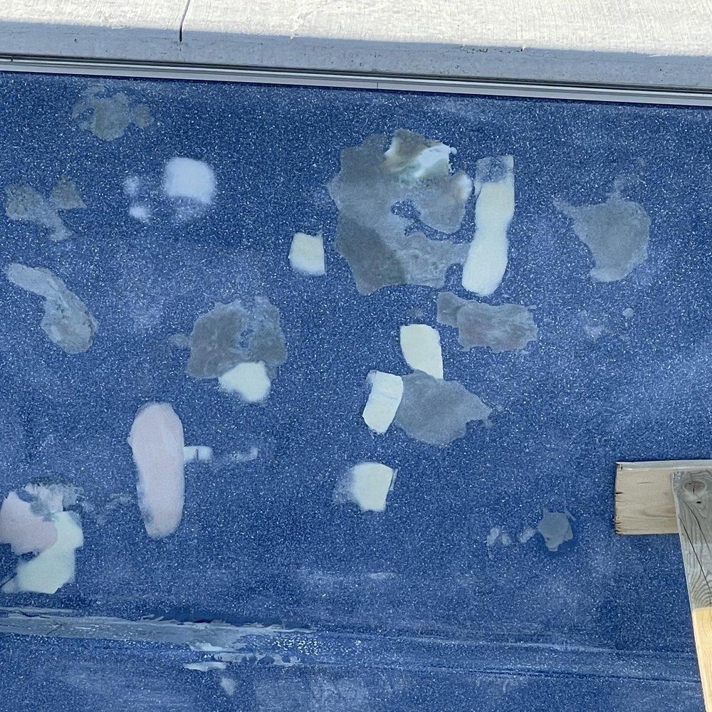 Backyard Paradise - a blue pool with broken glass - Landscaping Near Me