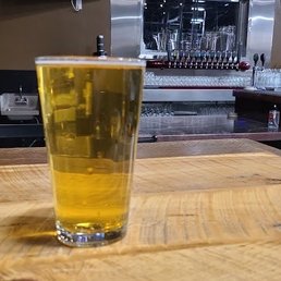 a glass of beer on a bar
