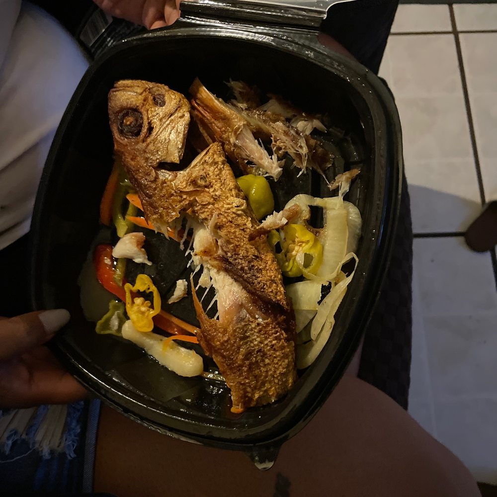 Dunns River Island Cafe Hallandale Beach - a person holding a pan of food - Caribbean Near Me - Hallandale Beach, Florida Dunns River Island Cafe Hallandale Beach - a person holding a pan of food - Caribbean Near Me - Hallandale Beach, Florida