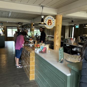 Kumama - a restaurant counter with people standing around it - Comfort Food Near Me - Jasper, Alberta Kumama - a restaurant counter with people standing around it - Comfort Food Near Me - Jasper, Alberta