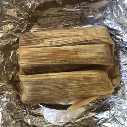 three tamales wrapped in foil