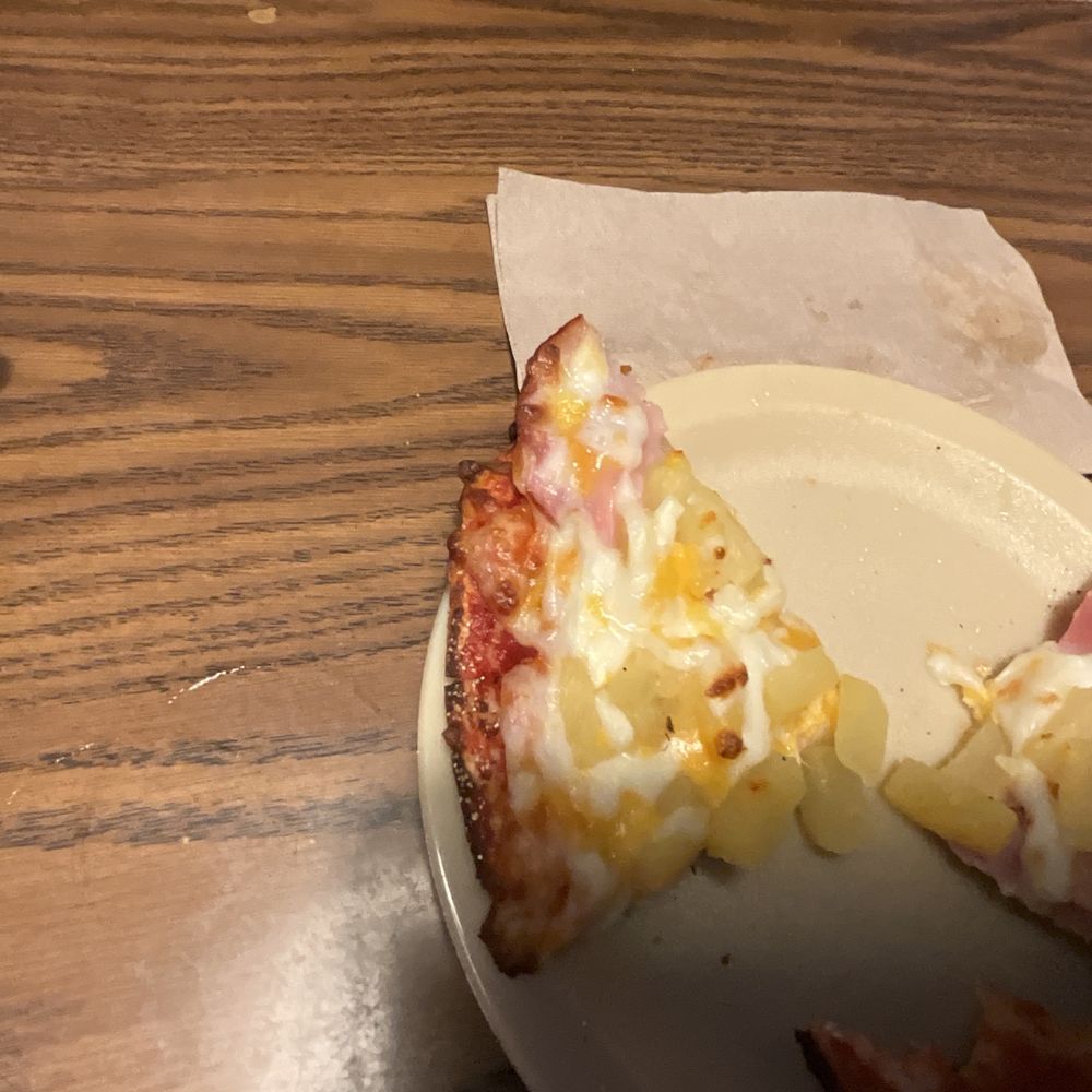 Pietro's Pizza - a half eaten pizza on a plate - Pizza Near Me - Salem, Oregon