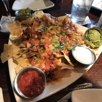 Houlihan's - Bar nachos from the happy hour menu. Still a large portion and enough to share! So good - New American Near Me - Brick Township, New Jersey Houlihan's - Bar nachos from the happy hour menu. Still a large portion and enough to share! So good - New American Near Me - Brick Township, New Jersey