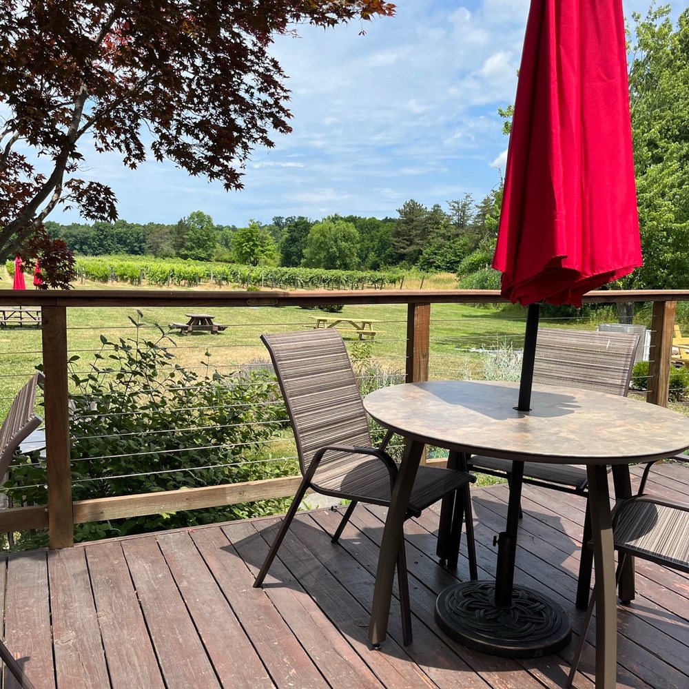 Hundley Cellars - a table and chairs on a deck - Wineries Near Me - Geneva, Ohio Hundley Cellars - a table and chairs on a deck - Wineries Near Me - Geneva, Ohio