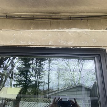 A.G. Reliable Remodeling - a person taking a picture of a window - General Contractors Near Me - Framingham, Massachusetts