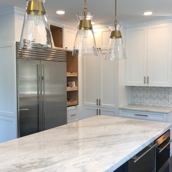 Solutions HRI, LLC - a kitchen with marble countertops and stainless steel appliances - General Contractors Near Me - Garden City Park, New York
