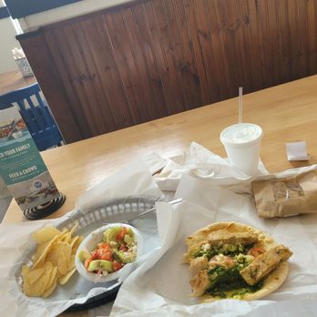 Taziki's Mediterranean Cafe - Plano - Basil-Pesto Chicken Gyro With a side of Scrumptious cucumber tomato salad,  nice chips,  a chocolate chip   water. - Mediterranean Near Me - Plano, Texas