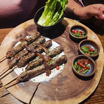 Immigrant Food Ballston - MEDITERRANEAN LAMB SKEWERS DIY lettuce wrap, labne, za'atar, dates, Thai chili - New American Near Me - Arlington, Virginia Immigrant Food Ballston - MEDITERRANEAN LAMB SKEWERS DIY lettuce wrap, labne, za'atar, dates, Thai chili - New American Near Me - Arlington, Virginia