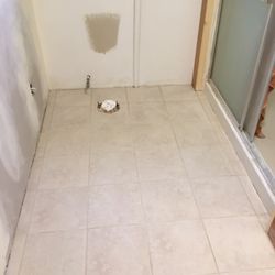 Montana Home Improvement Pros - New tile in bathroom and kitchen, also under woodstove