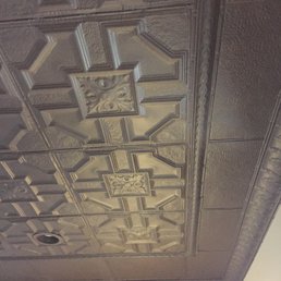 Tin ceiling from American Tin Ceilings showing pattern panels, transitional flat molding, filler tiles and crown molding.