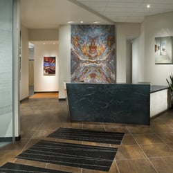 Stockett Tile & Granite Company - Stockett Tile & Granite's front desk.  Book match & veined matched granite.