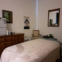 Replenish Massage & Skin Care Studio - Massage therapy table with cozy blanket, towel warmer cabinet