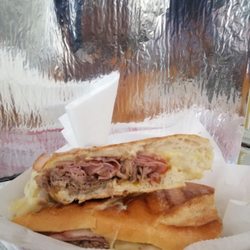 This is the Cuban Sandwich, almost 9 inches filled with pork, ham, cheese, mayo, mustard and pickles.