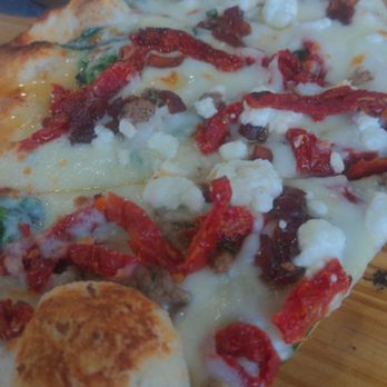 Grind At Kona Tiki Bar - Lamb pizza.. something sweet in this that isn't just the sundried tomatoes and very small amount of lamb that makes this a one time try - New American Near Me - Ormond Beach, Florida Grind At Kona Tiki Bar - Lamb pizza.. something sweet in this that isn't just the sundried tomatoes and very small amount of lamb that makes this a one time try - New American Near Me - Ormond Beach, Florida