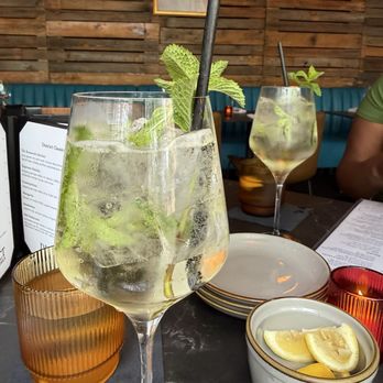 District Kitchen & Cocktails - This drink is a great summer drink, Hugo Spritz! - New American Near Me - Austin, Texas District Kitchen & Cocktails - This drink is a great summer drink, Hugo Spritz! - New American Near Me - Austin, Texas