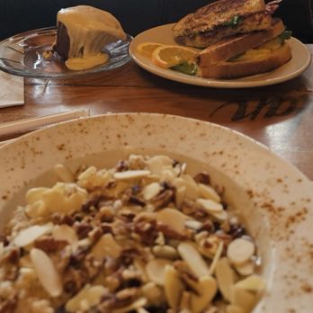 Raven Coffeehouse & Cafe - Oatmeal in the foreground, BELT breakfast sandwich, along with a frosted cinnamon muffin. - Cafes Near Me - Port Huron, Michigan