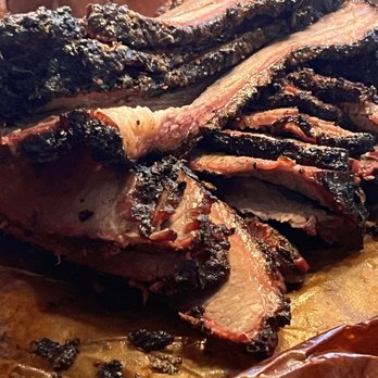 Kasper’s BBQ & Hummus - a rack of ribs on a cutting board - Barbeque Near Me Kasper’s BBQ & Hummus - a rack of ribs on a cutting board - Barbeque Near Me
