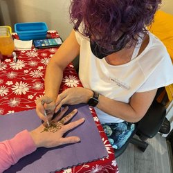 Jody doing henna at a house party.