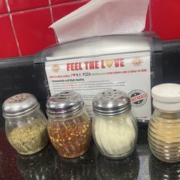Garlic, oregano, parm cheese, red pepper flakes..... on the tables Garlic, oregano, parm cheese, red pepper flakes..... on the tables