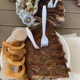 Full Slab Slow Smoked St. Louis Ribs, Onion Rings, Loaded Fries.