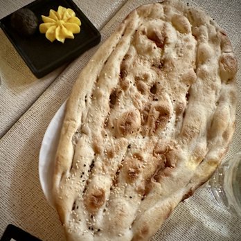 Darvish Kitchen - Large flatbread with ghee and what we think was a yummy olive tapenade type spread - Persian/Iranian Near Me - Washington, DC, District of Columbia