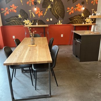 Grafika Coffee - a table and chairs in a coffee shop - Coffee & Tea Near Me