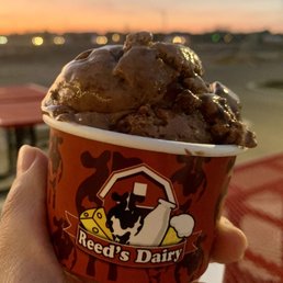 a hand holding a cup of ice cream a hand holding a cup of ice cream