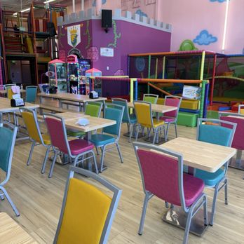 Kids Empire Paramus - Indoor play center with tables, chairs, and a multi-level play structure at Kids Empire Paramus, NJ. - Kids Activities Near Me - Paramus, New Jersey