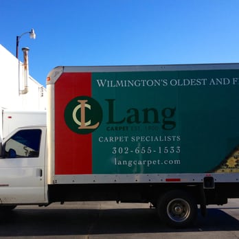 Lang Carpet - a truck parked in front of a building - Carpet Cleaning Near Me - Wilmington, Delaware