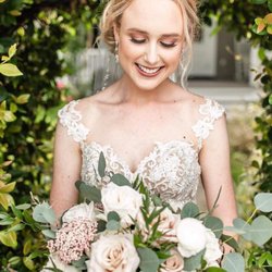 The Grand Magnolia Ballroom and Suites - A beautiful bride framed by our Jasmine archway at Grand Magnolia